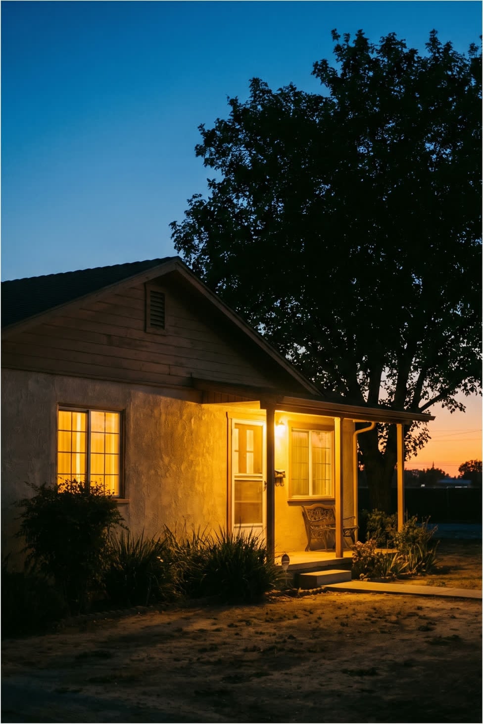 A Northern California home at dusk with warm interior lighting